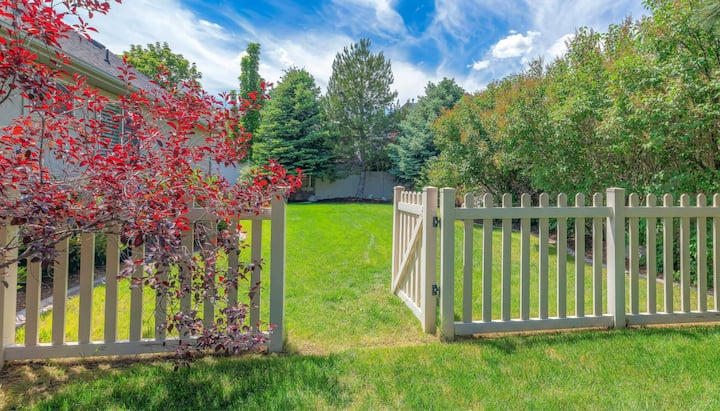 A functional fence gate providing access to a well-maintained backyard, surrounded by a wooden fence in Melbourne